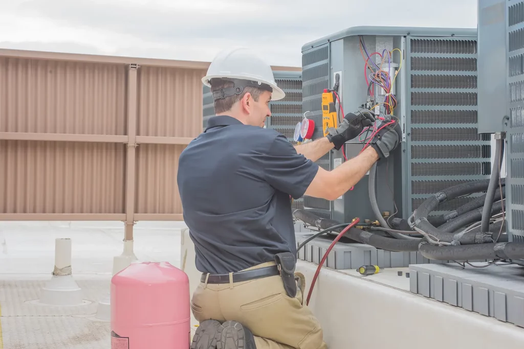 Technician performing commercial H V A C maintenance 