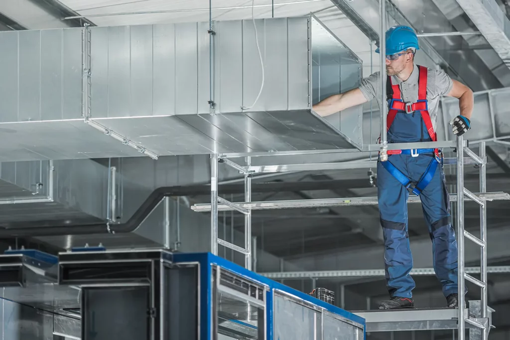 H V A C technician performing commercial maintenance